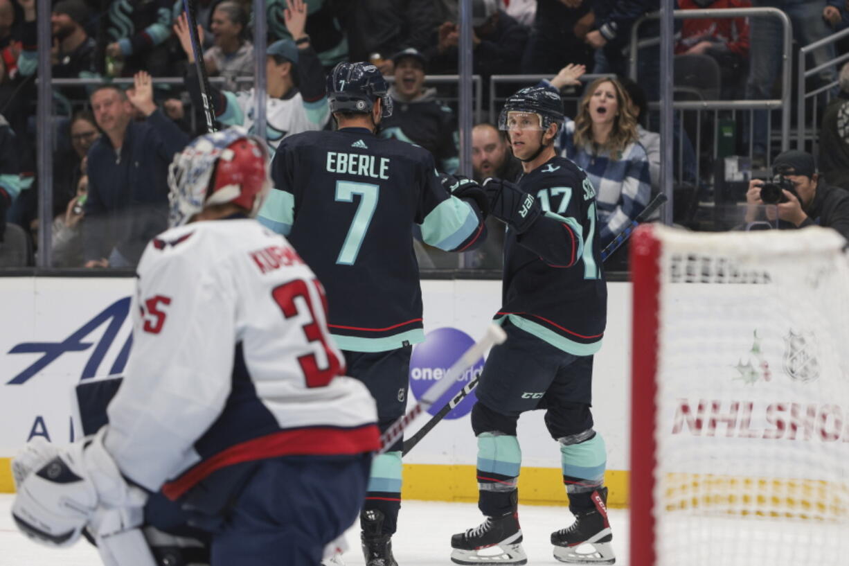 Seattle Kraken center Jaden Schwartz (17) celebrates after his goal with right wing Jordan Eberle as Washington Capitals goaltender Darcy Kuemper looks on during the second period of an NHL hockey game Thursday, Dec. 1, 2022, in Seattle.