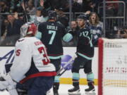 Seattle Kraken center Jaden Schwartz (17) celebrates after his goal with right wing Jordan Eberle as Washington Capitals goaltender Darcy Kuemper looks on during the second period of an NHL hockey game Thursday, Dec. 1, 2022, in Seattle.