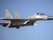 FILE - In this undated file photo released by the Taiwan Ministry of Defense, a Chinese PLA J-16 fighter jet flies in an undisclosed location. China's military sent 71 planes, including J16 fighter jets, and seven ships toward Taiwan in a 24-hour display of force directed at the island, Taiwan's defense ministry said Monday, Dec. 26, 2022, after China expressed anger at Taiwan-related provisions in a U.S.