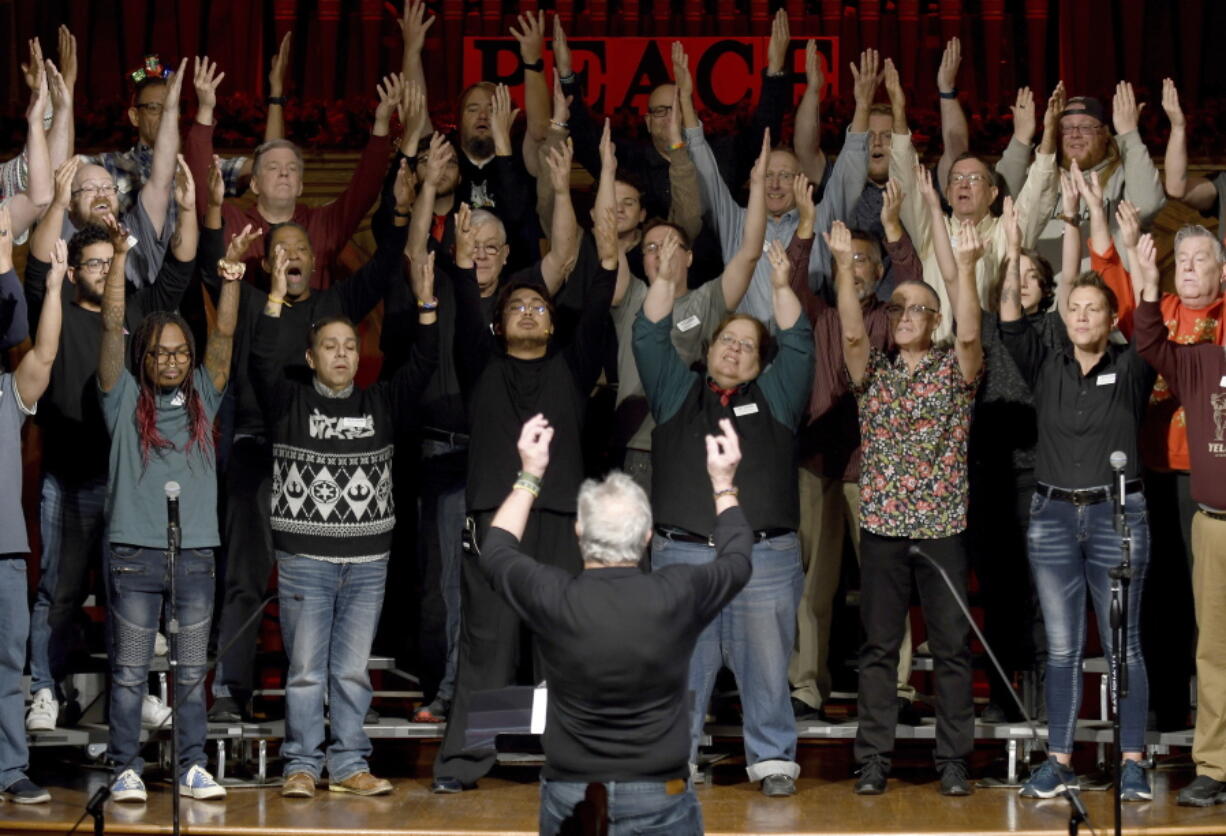 Bill Loper, interim artistic director of the Out Loud Colorado Springs Men's Chorus, leads the group during a rehearsal for its Christmas program in Colorado Springs, Colo., on Wednesday, Nov. 30, 2022. Gay and lesbian choruses like Out Loud came about after the assassination of San Francisco Supervisor Harvey Milk and have remained steadfast institutions through the civil rights struggles of the 20th century up to today. They've taken an active role in the healing process after mass shootings like that at Orlando's Pulse nightclub and the Nov. 19 attack at an LGBTQ nightclub in Colorado Springs that killed five people.