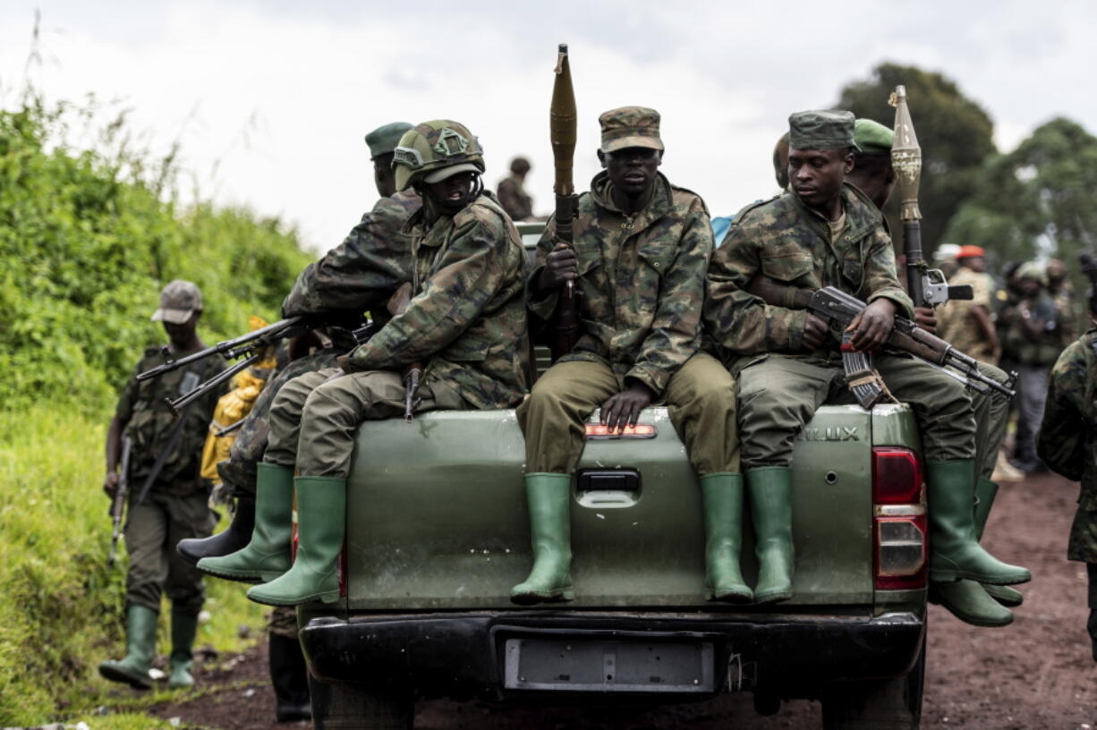 M23 rebels prepare to leave after a ceremony to mark the withdrawal from their positions in the town of Kibumba, in the eastern of Democratic Republic of Congo, Friday, Dec. 23, 2022. M23 rebels retreated from a village in eastern Congo Friday in the group's first withdrawal from an occupied village since it seized swaths of land months ago.