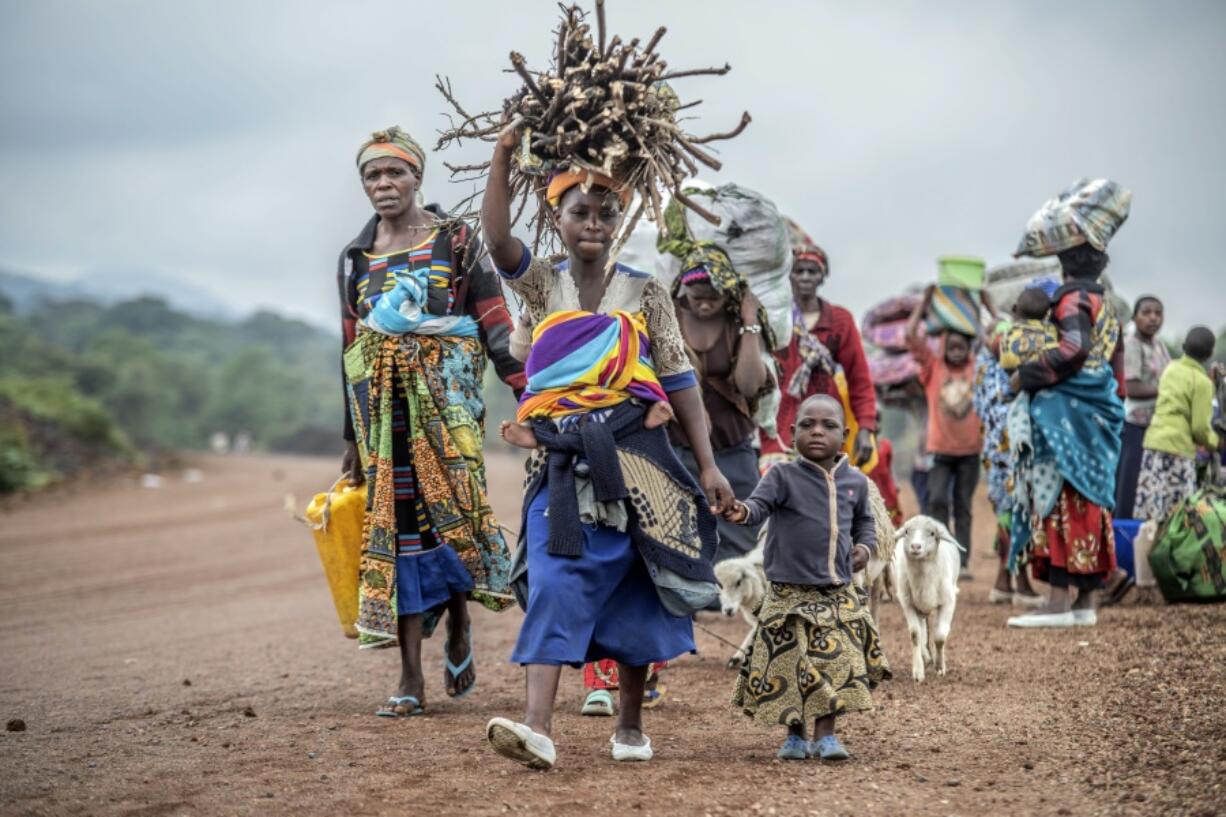 FILE - Residents flee fighting between M23 rebels and Congolese forces near Kibumba, some 20 kms ( 12 miles) North of Goma, Democratic republic of Congo, on Oct. 29, 2022. The accounts are haunting. Abductions, torture, rapes. Scores of civilians including women and children have been killed by the M23 rebels in eastern Congo, according to a U.N. report expected to be published this week.