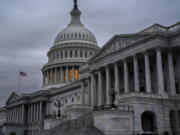 The Senate side of the Capitol is seen in Washington, early Thursday, Dec. 22, 2022, as lawmakers rush to complete passage of a bill to fund the government before a midnight Friday deadline, at the Capitol in Washington, Thursday, Dec. 22, 2022. (AP Photo/J.