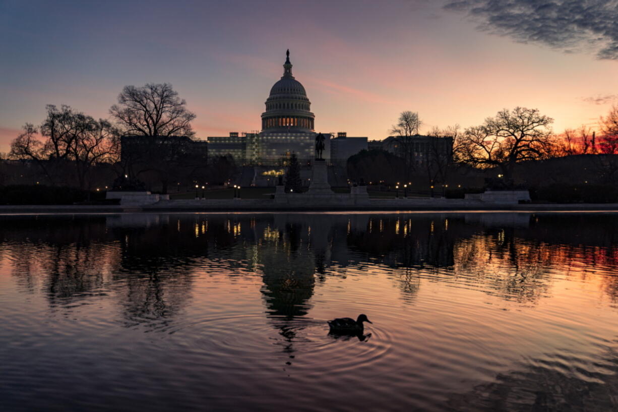 The Capitol is seen in Washington, early Wednesday, Dec. 14, 2022. Lawmakers leading the negotiations on a bill to fund the federal government for the current fiscal year say they've reached agreement on a "framework" that should allow them to complete work on the bill over the next week and avoid a government shutdown. (AP Photo/J.