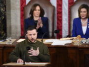 Ukrainian President Volodymyr Zelenskyy addresses a joint meeting of Congress on Capitol Hill in Washington, Wednesday, Dec. 21, 2022. Vice President Kamala Harris and Speaker of the House Nancy Pelosi, D-Calif., right, listen.