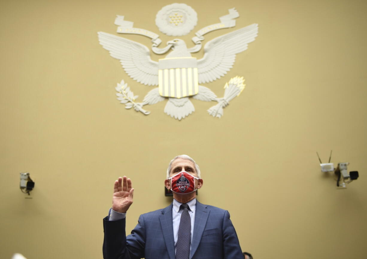 FILE - Dr. Anthony Fauci, director of the National Institute for Allergy and Infectious Diseases, is sworn in before a House Subcommittee on the Coronavirus crisis hearing, July 31, 2020 on Capitol Hill in Washington. Fauci steps down from a five-decade career in public service at the end of the month, one shaped by the HIV pandemic early on and the COVID-19 pandemic at the end.