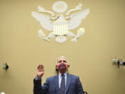 FILE - Dr. Anthony Fauci, director of the National Institute for Allergy and Infectious Diseases, is sworn in before a House Subcommittee on the Coronavirus crisis hearing, July 31, 2020 on Capitol Hill in Washington. Fauci steps down from a five-decade career in public service at the end of the month, one shaped by the HIV pandemic early on and the COVID-19 pandemic at the end.