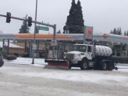 City of Vancouver snow plows are out in the streets clearing thoroughfares on Friday but roads are still hazardous.