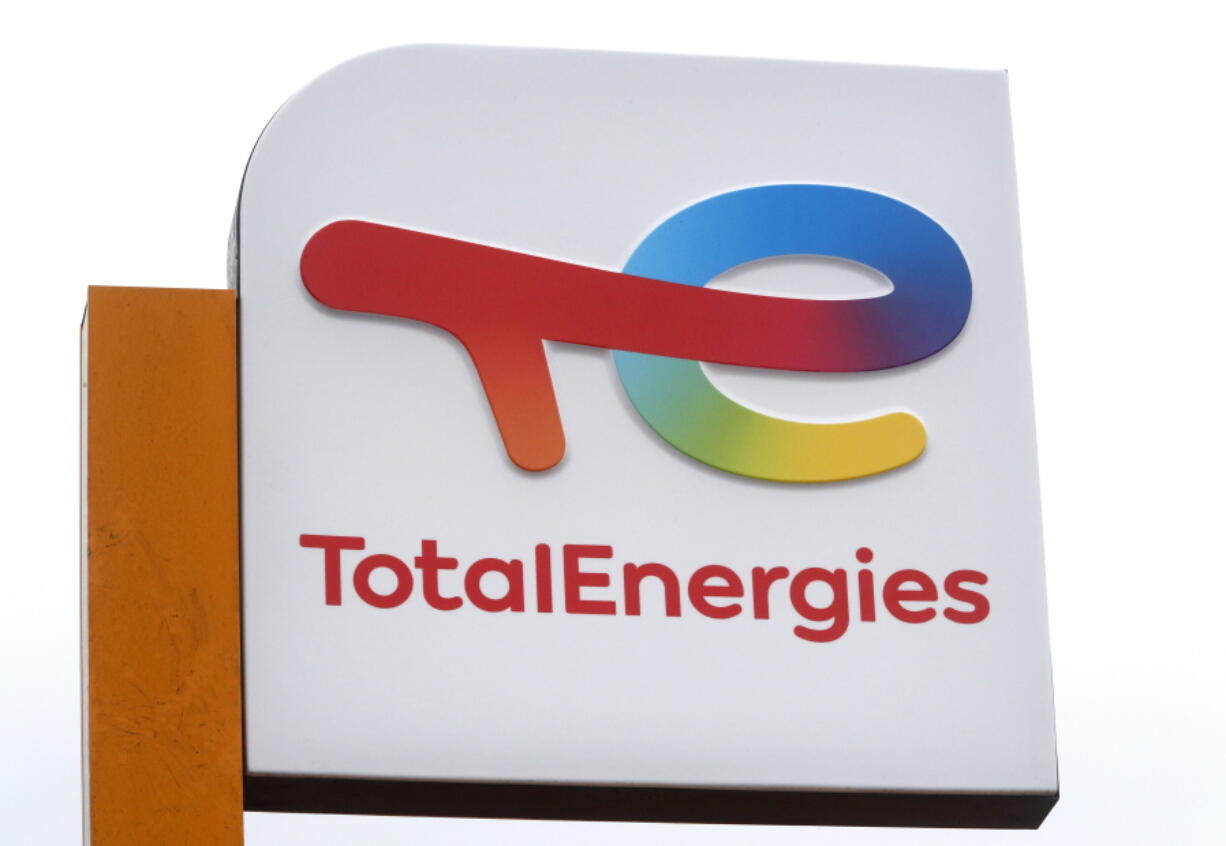 FILE - The logo of French energy conglomerate TotalEnergies is seen at a gas station in Lille, northern France, Tuesday, March. 1, 2022. French oil giant TotalEnergies announced Friday Dec.9, 2022 its decision to withdraw its representatives from the board of Russian gas producer Novatek and to take a $3.7 billion write-down in its accounts.