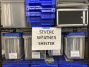 Plans for the activation of emergency severe weather shelters sit in bins at a warehouse in Portland, Ore., on Wednesday, Dec. 21, 2022, as officials open four such shelters in advance of an unusually cold weather system and ice storm. Parts of the Pacific Northwest are experiencing frigid temperatures, with potentially dangerous winter weather conditions expected to grip the region for the rest of the week.