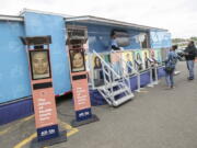 FILE - People stand by the All of Us Mobile Education and Enrollment Center at the Community Health Center on State Street in Meriden, Conn., May 13, 2019. Thousands of Americans who shared their DNA for science are about to learn something in return: if they harbor some problematic genes. It's part of a massive National Institutes of Health project to unravel how people's genetics, environments and habits interact to mold their health.