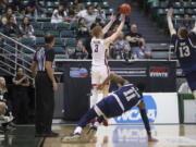 Washington State guard Jabe Mullins (3) makes a go-ahead 3-pointer in the closing seconds against George Washington in an NCAA college basketball game Thursday, Dec. 22, 2022, in Honolulu.