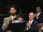 Southern California quarterback Caleb Williams holds the Heisman Trophy after winning the award Saturday, Dec. 10, 2022, in New York.