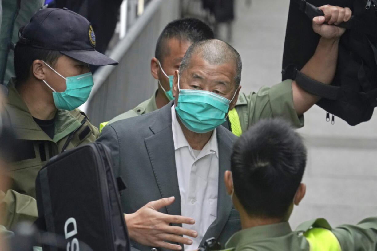 FILE - Democracy advocate Jimmy Lai, center, leaves the Hong Kong's Court of Final Appeal in Hong Kong on Feb. 9, 2021. Lai was sentenced to five years and nine months in prison over two fraud charges linked to lease violations in Hong Kong on Saturday, Dec. 10, 2022 the latest of a series of cases against prominent activists that critics say are aimed at snuffing out dissidents in the city.