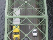 Cars and trucks travel north on the Interstate 5 Bridge, seen from the top of one of the northbound bridge lift towers.