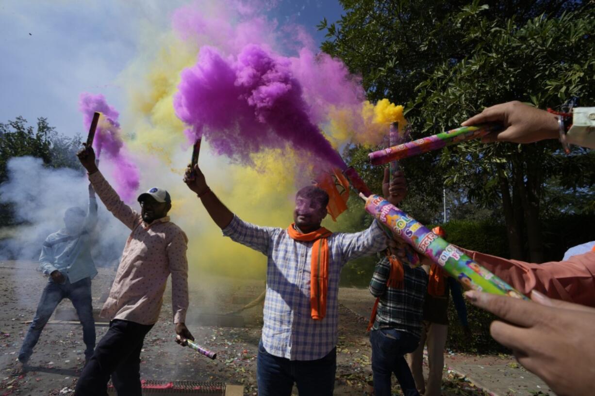 Bharatiya Janata party (BJP) supporters celebrate lead for the party in Gujarat state elections in Gandhinagar, India, Thursday, Dec. 8, 2022. Indian Prime Minister Narendra Modi's Hindu nationalist party is all set to keep its 27-year-old control of his home Gujarat state in a record state legislature win.