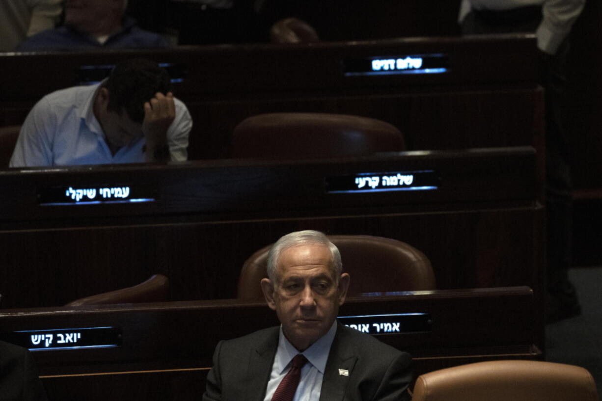 FILE - Israeli Prime Minister designate Benjamin Netanyahu, center, pauses during a session after Yariv Levin was selected as Speaker of the Knesset, Israel's parliament, in Jerusalem, Tuesday, Dec. 13, 2022. Netanyahu, has vowed to normalize relations with Saudi Arabia once he takes office. In an interview with the Saudi-owned Al-Arabiya network, Thursday, Dec.