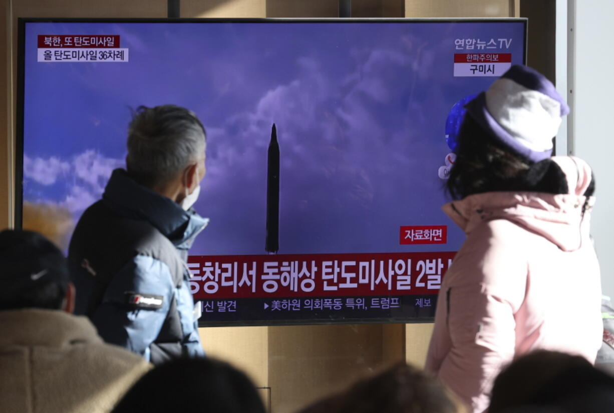 People watch a TV screen showing a news program about North Korea's missile launch with file footage, at the Seoul Railway Station in Seoul, South Korea, Sunday, Dec. 18, 2022. North Korea fired a pair of ballistic missiles on Sunday toward its eastern waters, its first weapons test in a month and coming two days after it claimed to have performed a key test needed to build a more mobile, powerful intercontinental ballistic missile designed to strike the U.S. mainland.