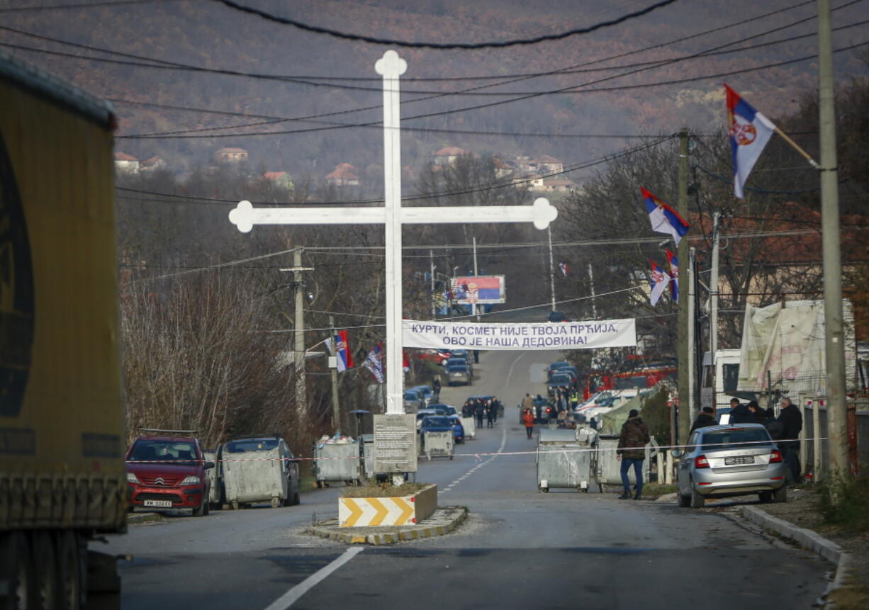 Serb protesters stand at the barricade near the village of Rudare, close to Zvecan, near the northern, Serb-dominated part of ethnically divided town of Mitrovica, Kosovo, Thursday, Dec. 29, 2022. Serbia's President Aleksandar Vucic says Serbs will start removing their barricades in Kosovo on Thursday in a move that deescalates tensions that triggered fears of new clashes in the Balkans.