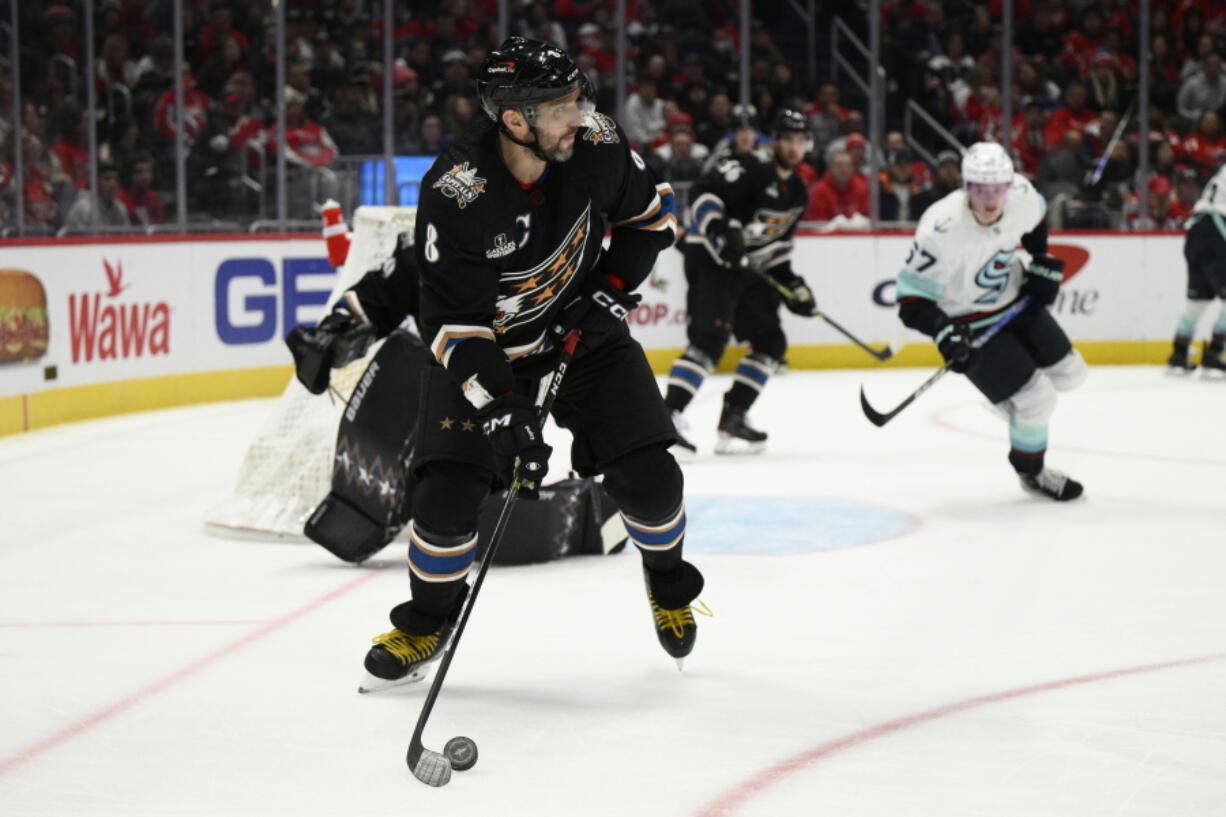 Washington Capitals left wing Alex Ovechkin (8) skates with the puck during the second period of the team's NHL hockey game against the Seattle Kraken, Friday, Dec. 9, 2022, in Washington.