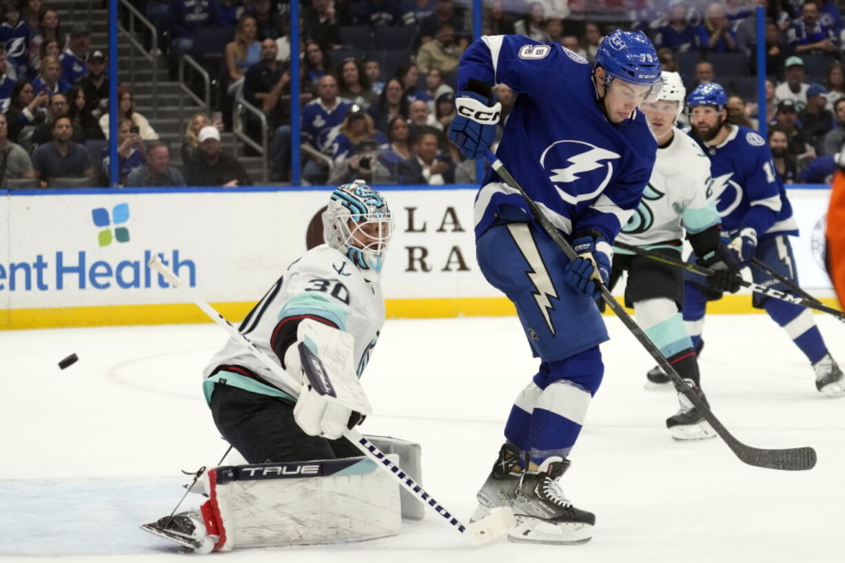 Tampa Bay Lightning center Ross Colton (79) deflects the puck past Seattle Kraken goaltender Martin Jones (30) for a goal during the second period of an NHL hockey game Tuesday, Dec. 13, 2022, in Tampa, Fla.