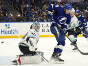 Tampa Bay Lightning center Ross Colton (79) deflects the puck past Seattle Kraken goaltender Martin Jones (30) for a goal during the second period of an NHL hockey game Tuesday, Dec. 13, 2022, in Tampa, Fla.