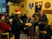 Amira Mansour, center, dances as Samir Damouni playing the Oud during community Christmas dinner for elderly residents at the only majority-Christian Palestinian refugee camp, in Dbayeh, north of Beirut, Lebanon, Wednesday, Dec. 21, 2022. Hundreds of thousands of Palestinians fled or were forced from their homes during the 1948 Mideast war over Israel's creation. Today, several million Palestinian refugees and their descendants are scattered across Jordan, Syria and Lebanon, as well as the West Bank and Gaza, lands Israel captured in 1967.