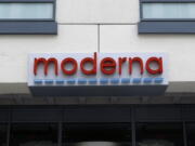 FILE - A sign marks an entrance to a Moderna building in Cambridge, Mass., on Monday, May 18, 2020.  Shares of Merck and Moderna jumped early Tuesday, Dec. 13, 2022,  after the drugmakers said a potential skin cancer vaccine they are developing using the same technology behind COVID-19 preventive shots did well in a mid-stage study.