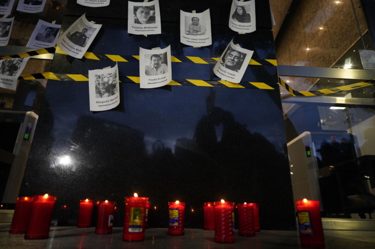 FILE - Photos of slain journalists are displayed on a wall during a vigil to protest the murder of journalist Fredid Roman, outside Mexico's Attorney General's office in Mexico City, Wednesday, Aug. 24, 2022. Roman was the 15th media worker killed so far this year in Mexico, where it is now considered the most dangerous country for reporters outside a war zone.