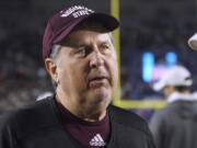 Mississippi State coach Mike Leach talks with Mississippi coach Lane Kiffin before an NCAA college football game in Oxford, Miss., Thursday, Nov. 24, 2022. (AP Photo/Rogelio V.