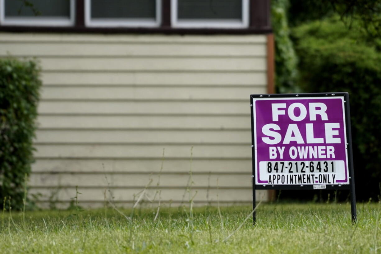 A sign is displayed in front of a home for sale in Prospect Heights, Ill., Thursday, July 10, 2022. Mortgage company Freddie Mac releases weekly mortgage rates on Friday, Dec. 15.  (AP Photo/Nam Y.