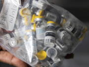 FILE - Vials of single doses of the Jynneos vaccine for mpox are seen from a cooler at a vaccinations site on Aug. 29, 2022, in the Brooklyn borough of New York. The federal government plans to end in January 2023 the public health emergency it declared earlier this year after an outbreak of mpox left more than 29,000 people across the U.S.