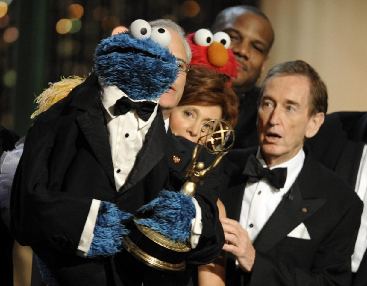 FILE - Bob McGrath, right, looks at the Cookie Monster as they accept the Lifetime Achievement Award for '"Sesame Street" at the Daytime Emmy Awards on Aug. 30, 2009, in Los Angeles. McGrath, an actor, musician and children's author widely known for his portrayal of one of the first regular characters on the children's show "Sesame Street" has died at the age of 90.  McGrath's passing was confirmed by his family who posted on his Facebook page on Sunday, Dec. 4, 2022.