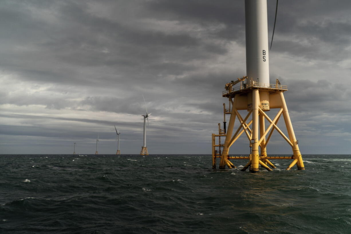 FILE - The five turbines of America's first offshore wind farm, owned by the Danish company, Orsted, stand off the coast of Block Island, R.I., in this, Oct. 17, 2022. The wind farm allowed residents of small Block Island to shut off five diesel generators. Tuesday, Dec. 6, marks the first-ever U.S. auction for leases to develop commercial-scale floating wind farms in the deep waters off the West Coast.