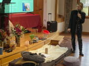 Gina Gratza, a trainer for students learning how to become psilocybin facilitators, shows the items that she would have at a dosing session, including mats, a pillow, a purge bucket, a sketch pad with colored pencils and tissues during a class near Damascus, Ore., on Dec. 2, 2022.