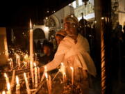 An Ethiopian woman and her child visit the Church of the Nativity, traditionally believed to be the birthplace of Jesus Christ, in the West Bank town of Bethlehem, Saturday, Dec. 3, 2022. Business in Bethlehem is looking up this Christmas as the traditional birthplace of Jesus recovers from a two-year downturn during the coronavirus pandemic. Streets are already bustling with visitors, stores and hotels are fully booked and a recent jump in Israeli-Palestinian fighting appears to be having little effect on the vital tourism industry.