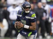 Seattle Seahawks quarterback Geno Smith (7) moves in the pocket against the Carolina Panthers during the first half of an NFL football game, Sunday, Dec. 11, 2022, in Seattle.