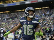 Seattle Seahawks wide receiver Tyler Lockett (16) celebrates his touchdown against the Carolina Panthers during the first half of an NFL football game, Sunday, Dec. 11, 2022, in Seattle.