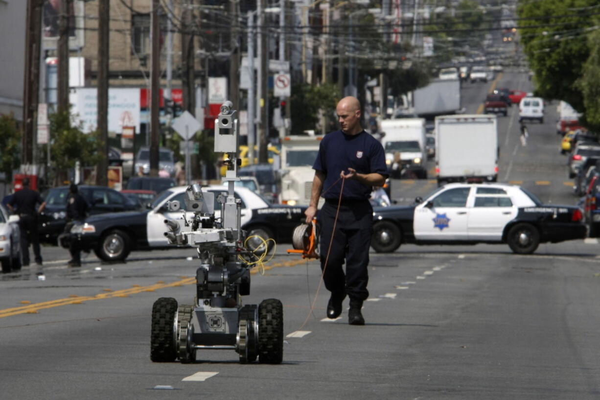 A police officer uses a robot to investigate a bomb threat in San Francisco, on July 25, 2008. The liberal city of San Francisco became the unlikely proponent of weaponized police robots on Tuesday, Nov. 29, 2022, after supervisors approved limited use of the remote-controlled devices, addressing head-on an evolving technology that has become more widely available even if it is rarely deployed to confront suspects.