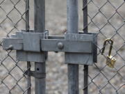 A Tacoma Power crew placed this new padlock at a substation gate after one that was cut off to break into the substation was taken away by law enforcement, Sunday, Dec. 25, 2022 in Graham, Wa.