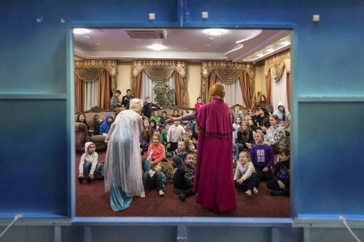 Theatre actors perform to children at the Dzherelo rehabilitation center during celebrations for Saint Nicholas Day, in Kyiv, Ukraine, Monday, Dec. 19, 2022. In a country where children have seen the horrors of a 10-month war, there are people trying to bring some peace and happiness to kids, at least for a moment during this holiday season in Ukraine. That has been happening this week in the outskirts of Kyiv at what used to be the upscale Venice hotel. Now it's a rehabilitation center housing children who have experienced the horrors of the Russian invasion.