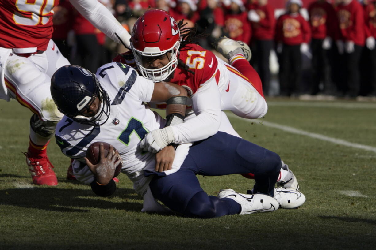 Seattle Seahawks quarterback Geno Smith (7) is sacked by Kansas City Chiefs defensive end Mike Danna (51) during the first half Saturday.