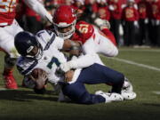 Seattle Seahawks quarterback Geno Smith (7) is sacked by Kansas City Chiefs defensive end Mike Danna (51) during the first half Saturday.