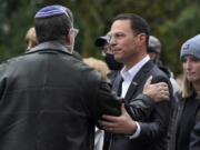 FILE - Pennsylvania Attorney General Josh Shapiro, center, attends a Commemoration Ceremony in Schenley Park, in Pittsburgh's Squirrel Hill neighborhood, on Wednesday, Oct. 27, 2021, three years after a gunman killed 11 worshippers at the Tree of Life Synagogue. Shapiro will be taking office as Pennsylvania's next governor in January 2023 after running a campaign in which he spoke early and often about his Jewish religious heritage. (AP Photo/Gene J.