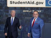 FILE - President Joe Biden answers questions with Education Secretary Miguel Cardona as they leave an event about the student debt relief portal beta test in the South Court Auditorium on the White House complex in Washington, Oct. 17, 2022. The Biden administration is no longer accepting applications for student loan forgiveness after a second federal court shut down the program.