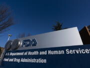 FILE - A sign in front of the Food and Drug Administration building is seen on Dec. 10, 2020, in Silver Spring, Md. The FDA's tobacco division is plagued by a lack of clear direction and priorities that have hampered its ability to regulate electronic cigarettes and other products under its oversight, according to a report released Monday, Dec. 19, 2022.