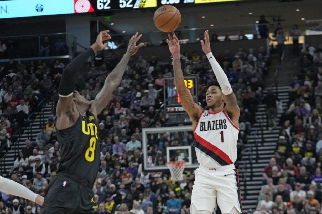 Portland Trail Blazers guard Anfernee Simons (1) shoots as Utah Jazz forward Jarred Vanderbilt (8) defends during the first half of an NBA basketball game Saturday, Dec. 3, 2022, in Salt Lake City.