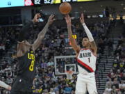 Portland Trail Blazers guard Anfernee Simons (1) shoots as Utah Jazz forward Jarred Vanderbilt (8) defends during the first half of an NBA basketball game Saturday, Dec. 3, 2022, in Salt Lake City.