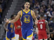 Golden State Warriors guard Jordan Poole (3) gestures after 3-point basket during the first half of the team's NBA basketball game against the Portland Trail Blazers in San Francisco, Friday, Dec. 30, 2022.