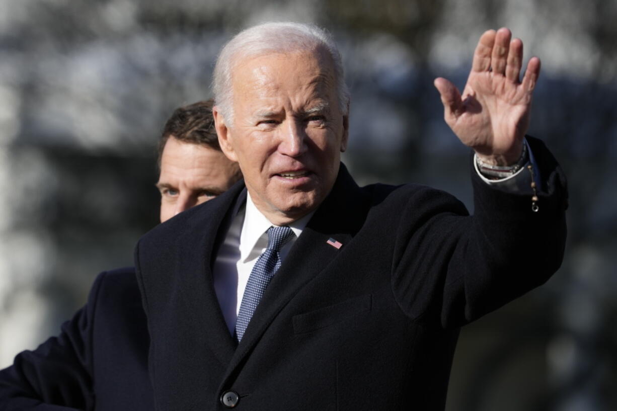 President Joe Biden and French President Emmanuel Macron stand on the stage during a State Arrival Ceremony on the South Lawn of the White House in Washington, Thursday, Dec. 1, 2022.